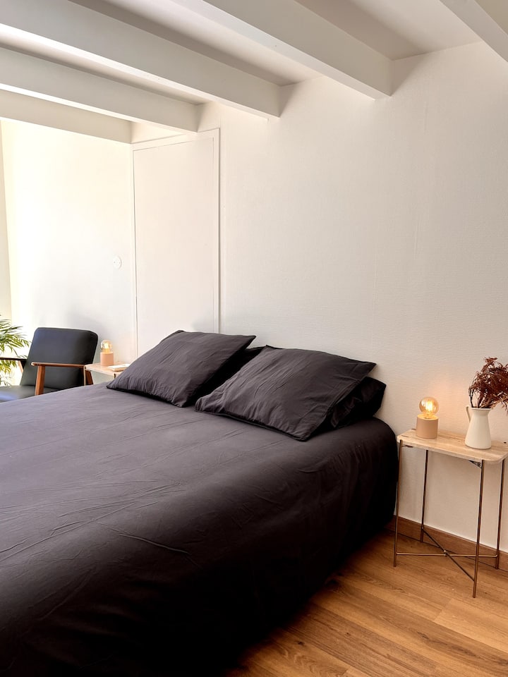 A bedroom for 2 people with its pretty marble bedside tables.