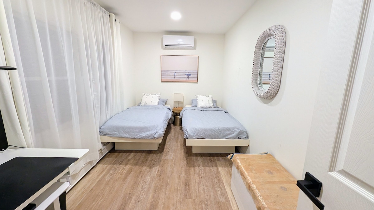 Bedroom with two beds and beach-themed decor