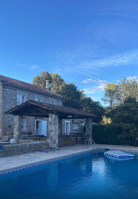 Old farmhouse in a wooded park with pool