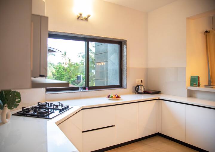 A spacious, fully equipped kitchen featuring a stove, gas, kettle, fridge, and microwave for your convenience.