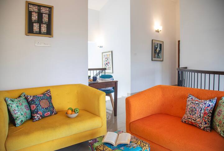 The TV room on the first floor, complete with balcony access and a swing for added relaxation.