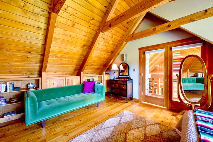 The Green Room features another spacious and comfortable king bed, lofted ceilings, a unique 'Romeo and Juliet Balcony' that overlooks the family room and...the Green Velvet Couch.