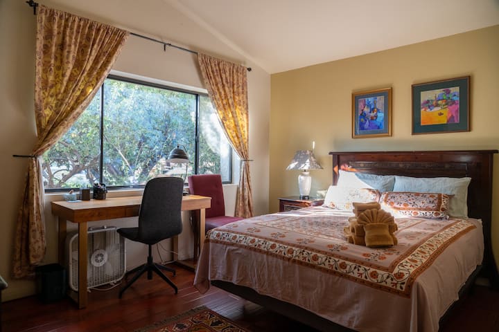 Guest bedroom (upstairs) features a working desk, walk-in closet, and semi-private en-suite bath (which also has access to the living area).