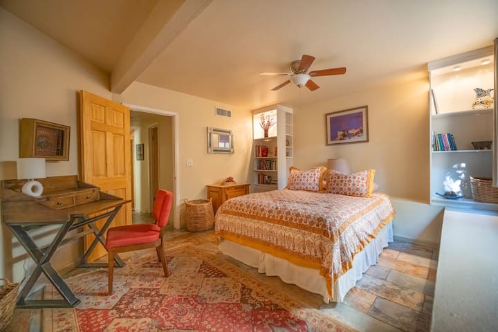 The downstairs bedroom in our lock-off unit features a writer's nook and plenty of books to read, with natural light.