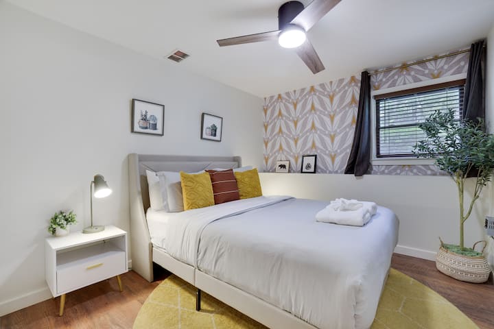 Charming Bedroom Retreat: Relax in a stylish space with vibrant decor and warm, inviting tones!