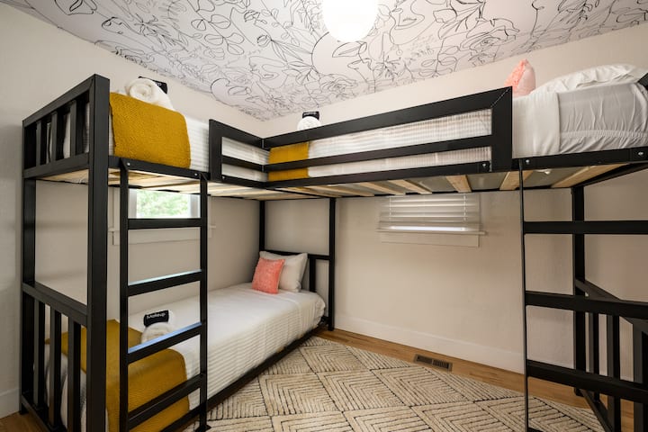 Sleepovers have never looked this good! Our stylish bunk room is just off the kitchen (on the main floor) and includes 3 twin beds
