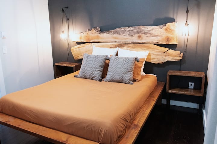 Inviting guest room with soft linens and forest-inspired vibes. Queen sized bedroom, can sleep 2. Including live-edge handcrafted artisan wood backboards.