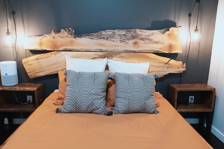 Inviting guest room with soft linens and forest-inspired vibes. Queen sized bedroom, can sleep 2. Including live-edge handcrafted artisan wood backboards.