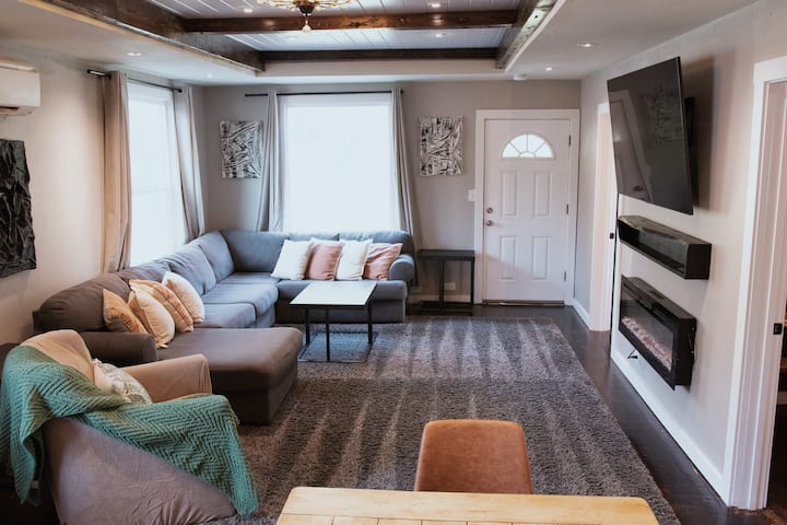 Main living room with cozy seating, fireplace, and room to relax. Plenty of sofa space to enjoy and make memories with your loved ones.