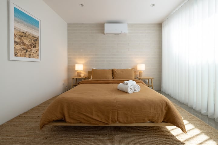 A delightful queen room located on the ground floor. It has its own heating and cooling system and opens to a private courtyard.