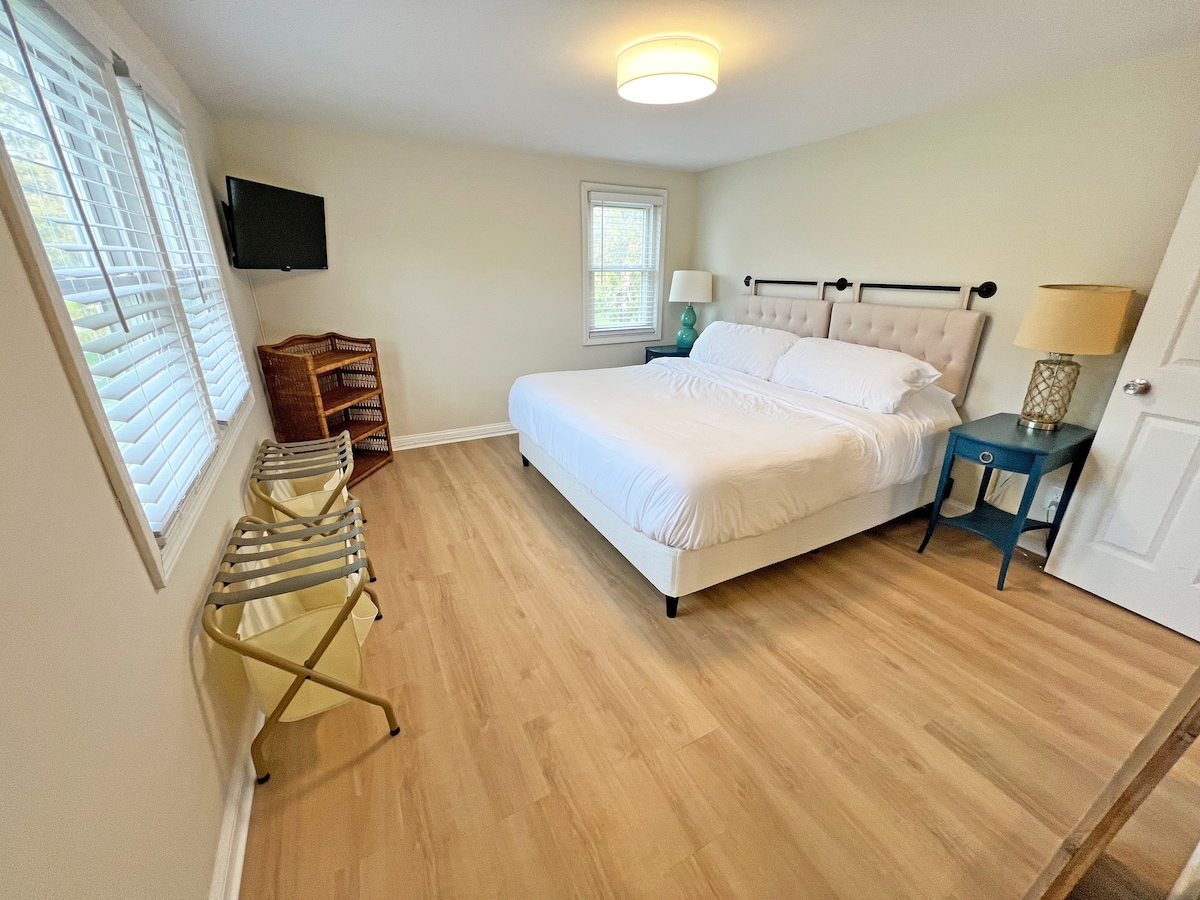 Primary bedroom with king-sized bed and large ensuite bathroom