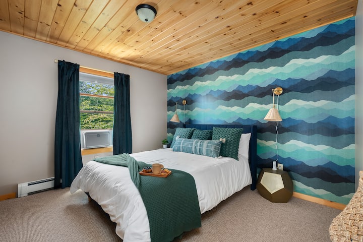 Upper Floor Suite—Retreat to the peaceful upper floor suite, sleeps 2, featuring a comfortable queen bed, Smart TV, & ample privacy.