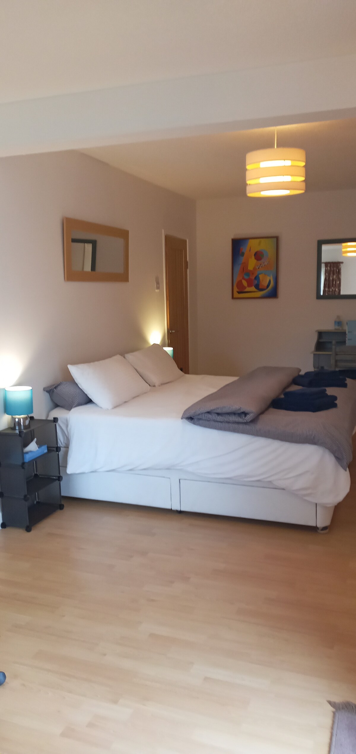 Superking bed (can be split into 2 singles), bedside tables, TV, built-in wardrobe and work space.