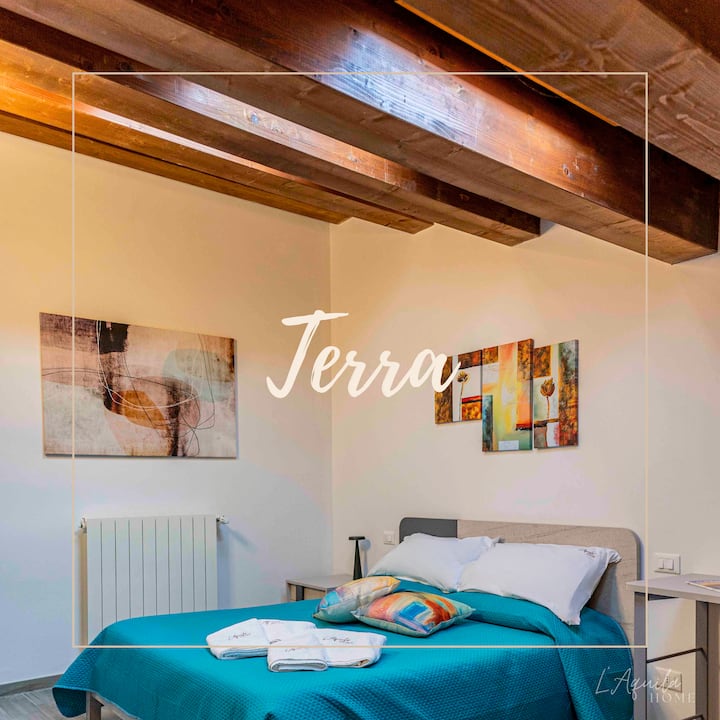 Room Terra 2° Piano : grande, caratteristica, con tetto in legno, 3 velux automatici per regolare la luce, letto matrimoniale e luci LED. Un'esperienza unica di comfort e atmosfera. Goditi il tuo soggiorno in un ambiente accogliente e suggestivo.
