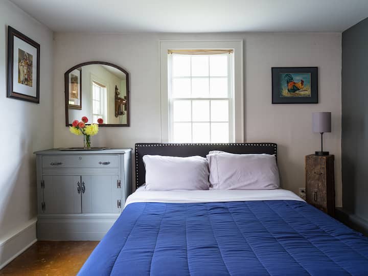Our first floor bedroom has a full bed and a television. 