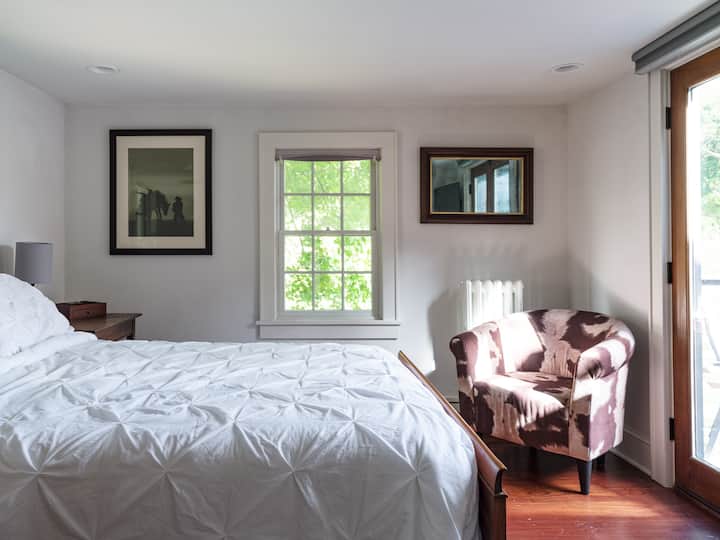 One of our two upstairs bedrooms has a queen bed and access to the balcony.