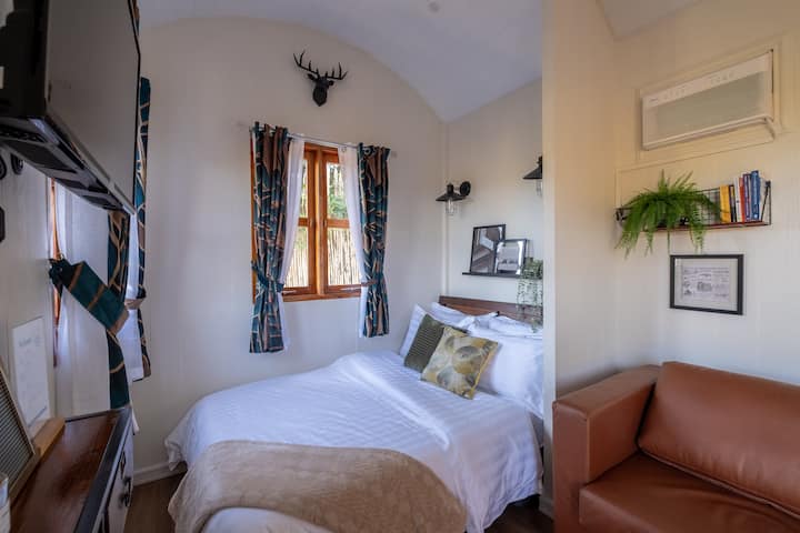 Double bed with luxurious pillows and linens. 