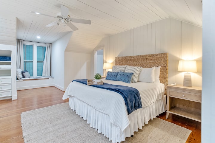 The master bedroom is upstairs and it has a king sized bed and a private bathroom.