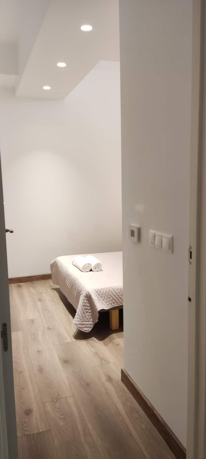 A bedroom with a double bed and an en-suite bathroom.