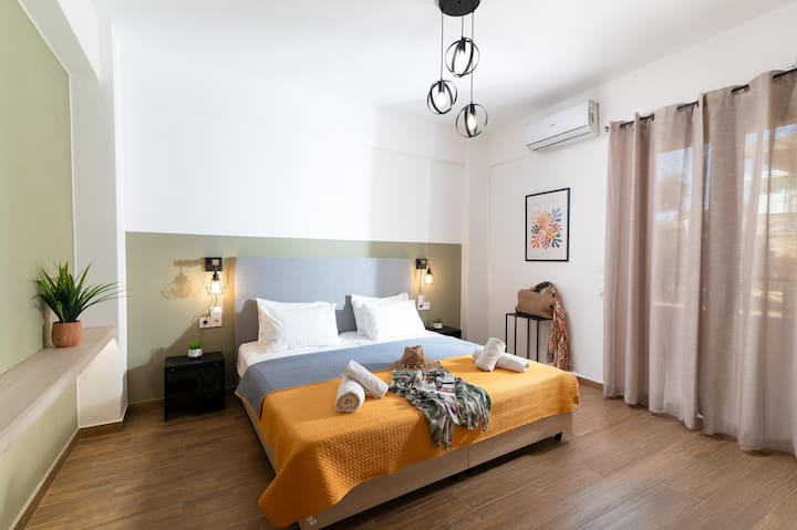 Second room offers a comfy double bed splitting into two singles, with a balcony door revealing peaceful garden views. Enjoy TV, Netflix, satellite channels, air conditioning, and fast internet. Ideally located next to the smaller bathroom.