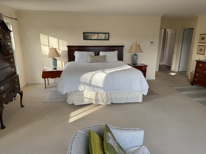 The Master bedroom has a cal king in a large, sunny and spacious room with a large bay window with a couch, overlooking the rose garden and mountains.