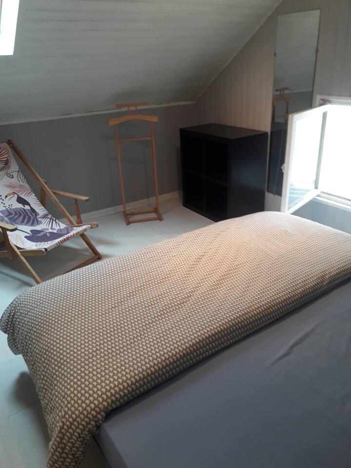 Large bedroom with double bed and storage