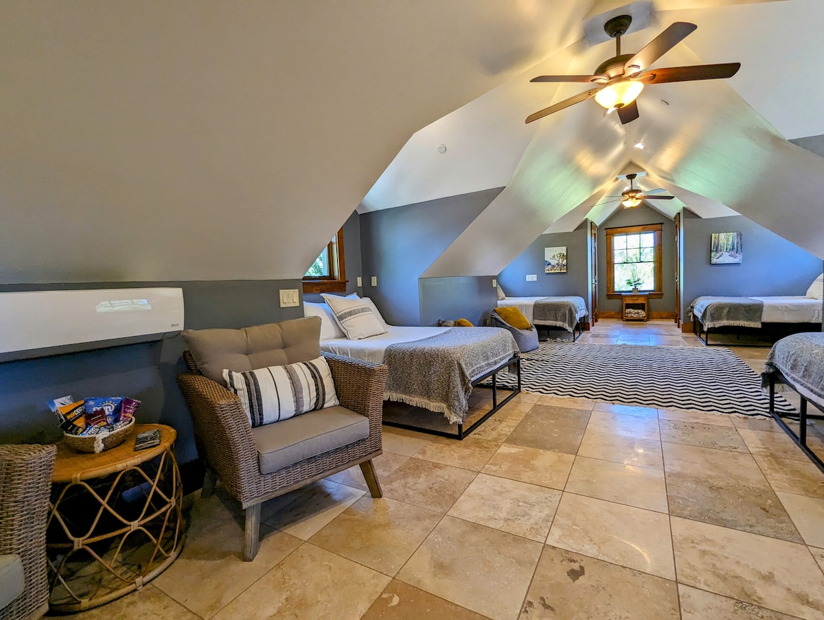 The bunkhouse loft-style bedroom is located upstairs and features 4 double beds, flat screen TV, full kitchen and bathroom