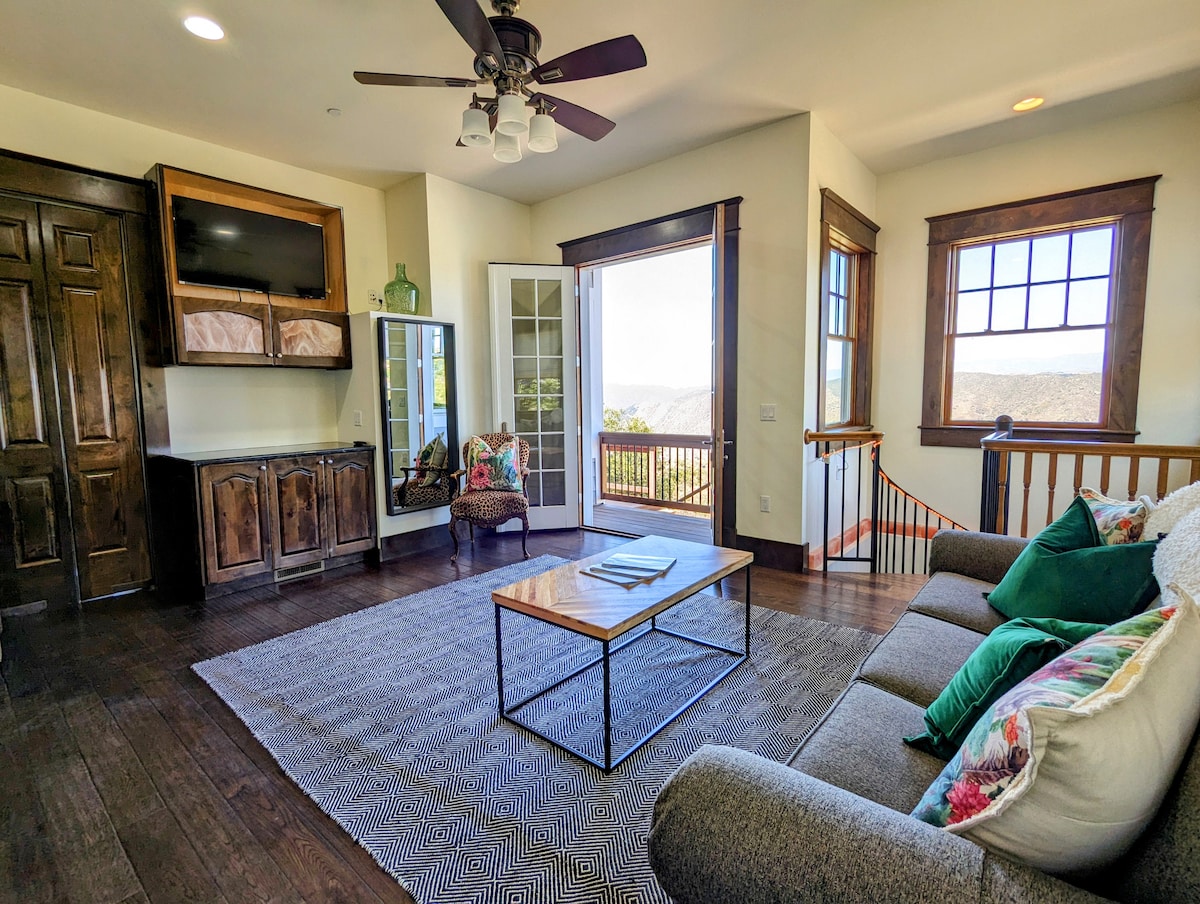 Den with convertible queen sofa bed, flat screen TV, double french doors to back porch, and full bathroom just a few steps away