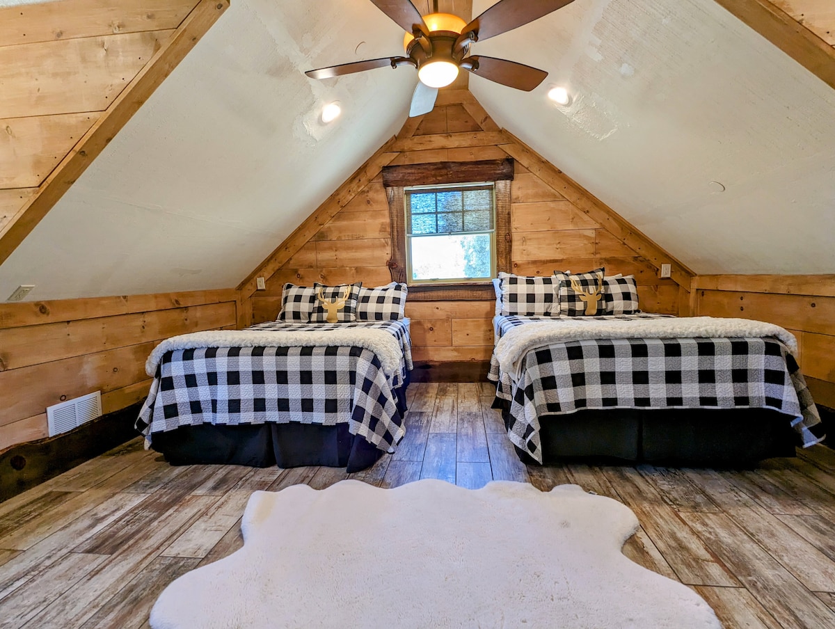 Lodge bedroom featuring one queen bed, one full bed, and walk-in closet