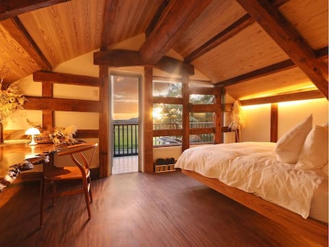 A panoramic view of Mt. Aso from the bedroom. Stay in a 200-year-old rice warehouse that weaves time