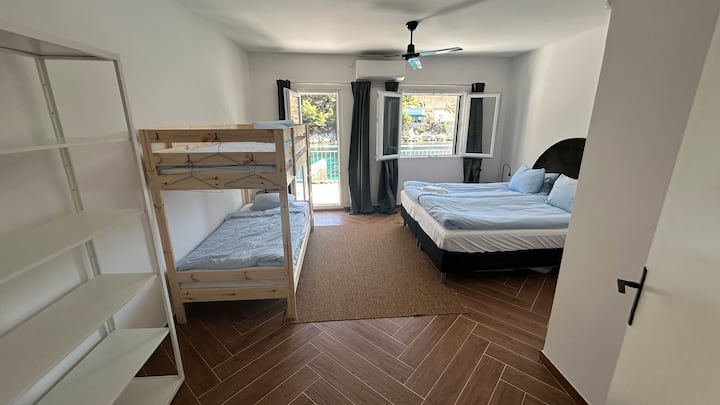 Wake up to the peaceful noise of the sea! A cozy bedroom with divisible double bed, bunk bed, AC, ceiling fan and blackout curtains. Direct exit to a sunny balcony – the sea is only 2 meters away! ☀️







