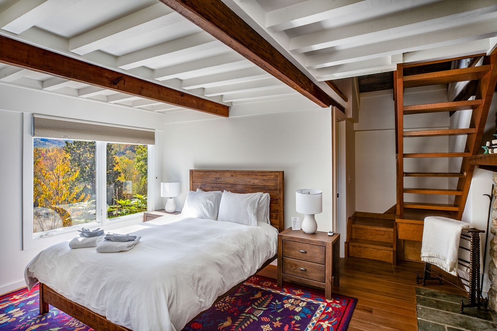 In the Cottage (available to rent for an additional fee): This lovely queen bedroom has its own private bathroom (by the stairs) and steps up to a separate loft with 3 additional single beds. 
