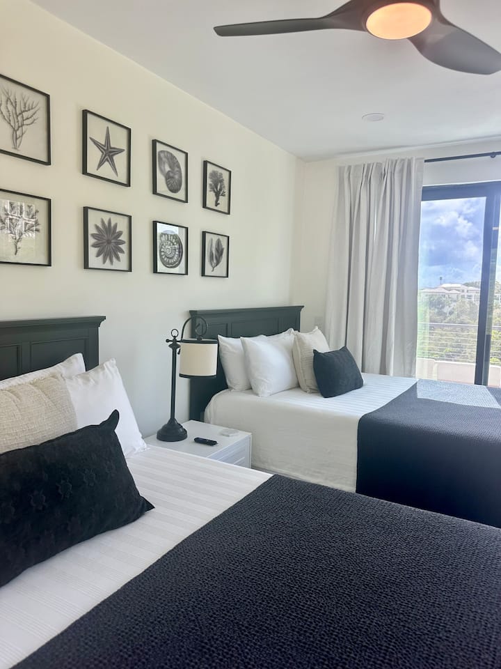 This room is gorgeous with 2 queen beds.  The Black Pearl Suite, the second bedroom off the entryway. Large en suite bath with double sinks.