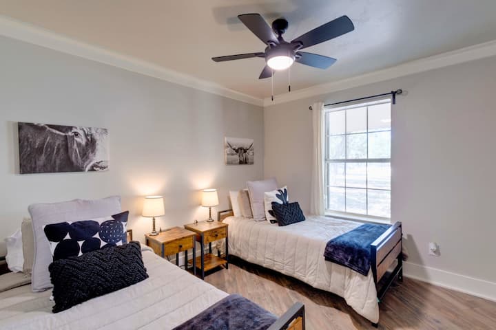 Bright bedroom with two twin beds and an extra pull-out twin—perfect for kids, friends, or groups needing flexible sleeping near Salado.