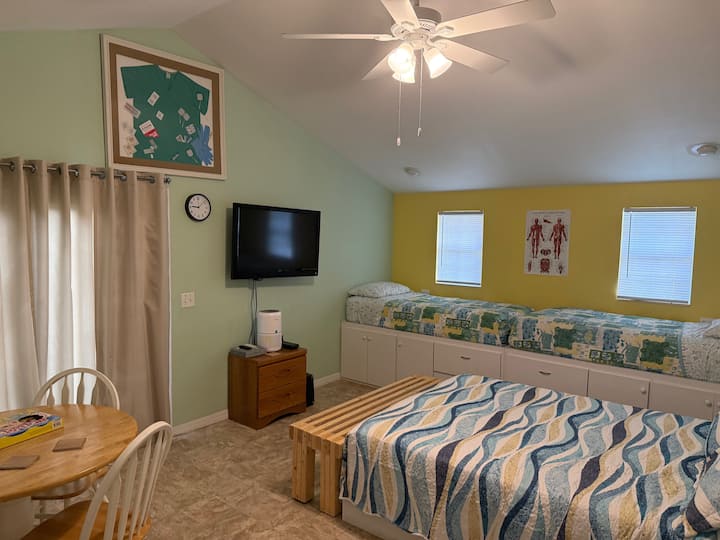 This Medical themed bedroom has 4 Twin Beds and 1 Queen Bed! This fun room has a ceiling fan, Roku TV,  levoit air purifier, DVD player & variety of DVDs, loaded with game & books, tons of storage, a table with chairs and bench, 2 charging plugs.