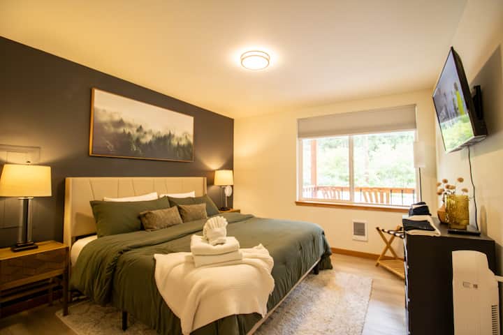 The first-floor master bedroom includes a king-sized bed, large closet, flatscreen TV, dresser, black-out shades, night stands, individual lamps and a luggage rack.