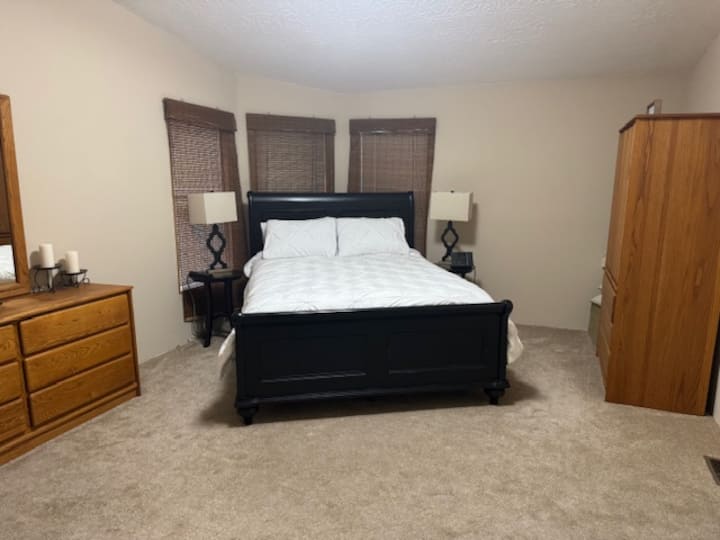 Bedroom 1 with Queen size bed, large walk-in closet, ensuite bathrooom, two dressers and two nightstands.