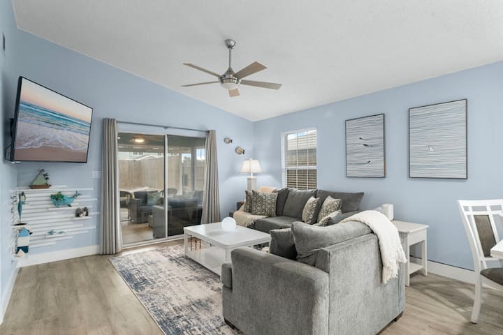 From Beach to Couch: Enjoy the Best of Both Worlds Here featuring a 65" Smart TV and a Queen-Size pull-out couch.