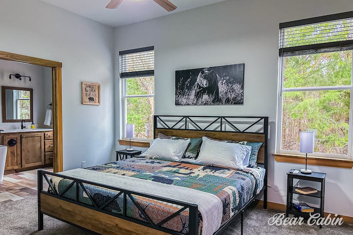The master bedroom features a smart tv, and ceiling fan. Also has a huge walk-in closet for you to hang your clothes, luggage racks, and the corn hole boards. 