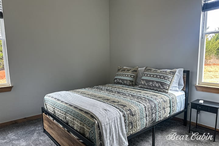 The bedroom in the far back to the left features a queen size bed, and a ceiling fan. Also has a closet for you to hang your clothes.