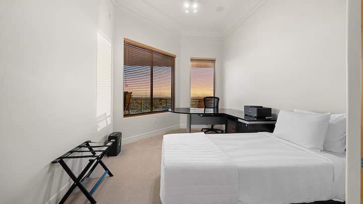 The second bedroom offers a cozy retreat with a productive side.