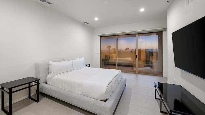 Clean and simple bedroom with a great view and a big TV. Perfect for a chill getaway!