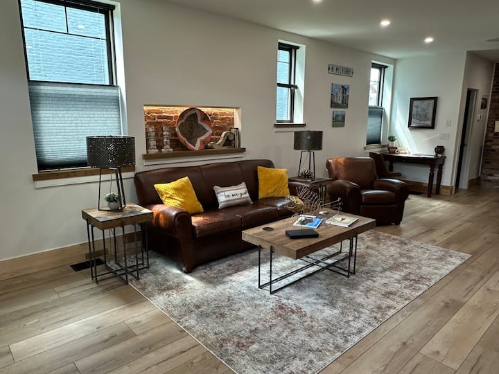 Living room with full size sleeper sofa and recliner
