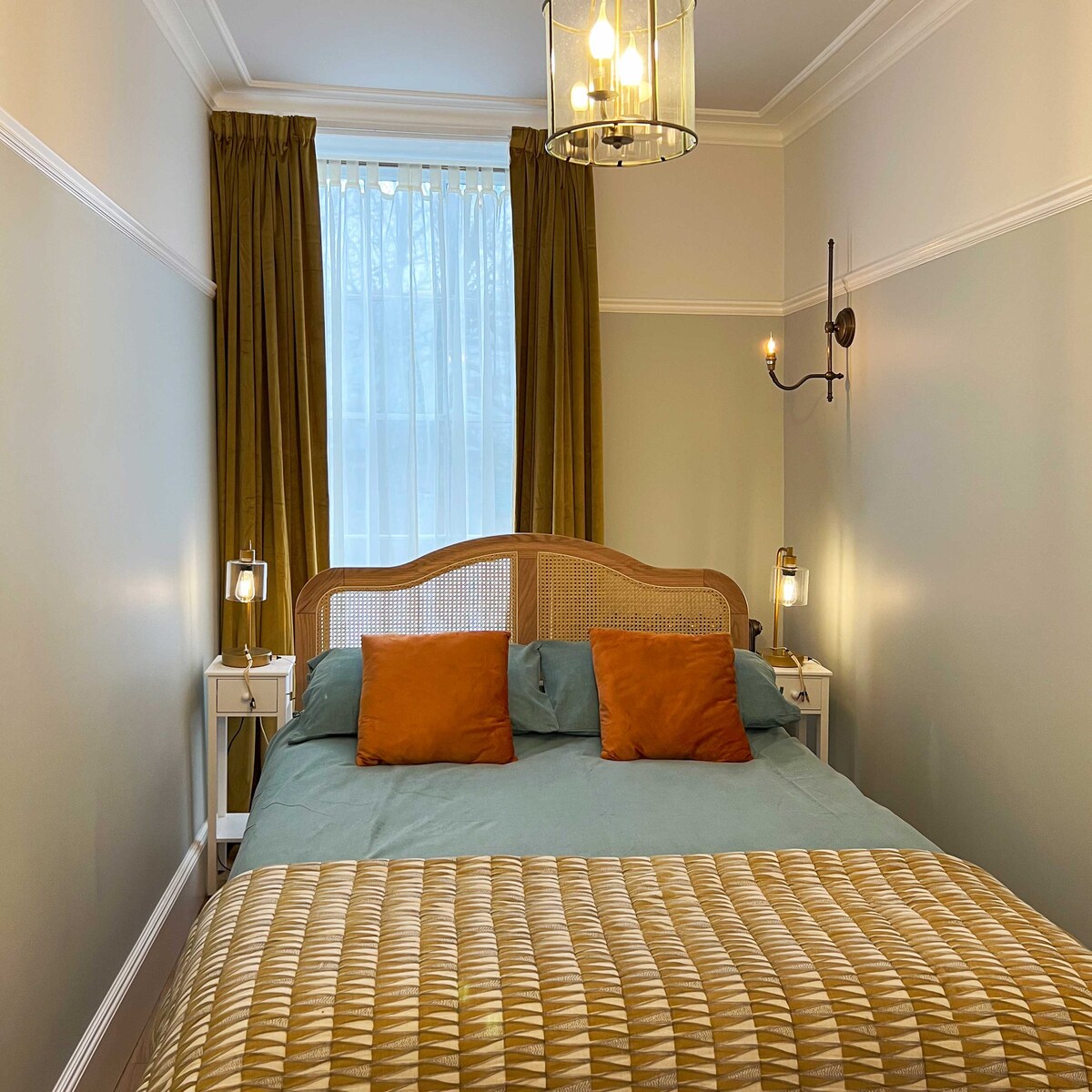 The cosy bedroom has period-style lighting plus USB charging cables on each side of the double bed.