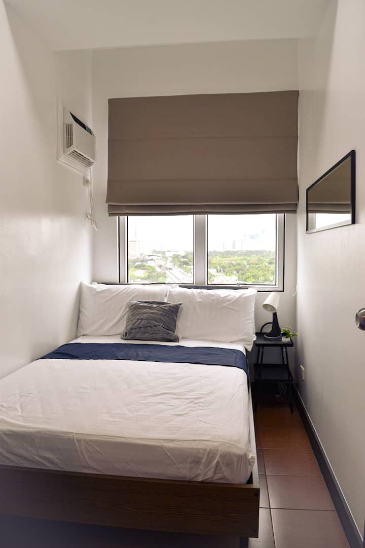 Features a double size bed, air-conditioning unit, side table, lamp and mirror.
