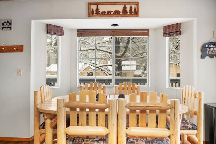 What a view to enjoy your morning cup of Joe. Our bright and cozy dining area features a rustic wooden dining table with matching log-style chairs, and cushioned seats with nature-inspired decor. 