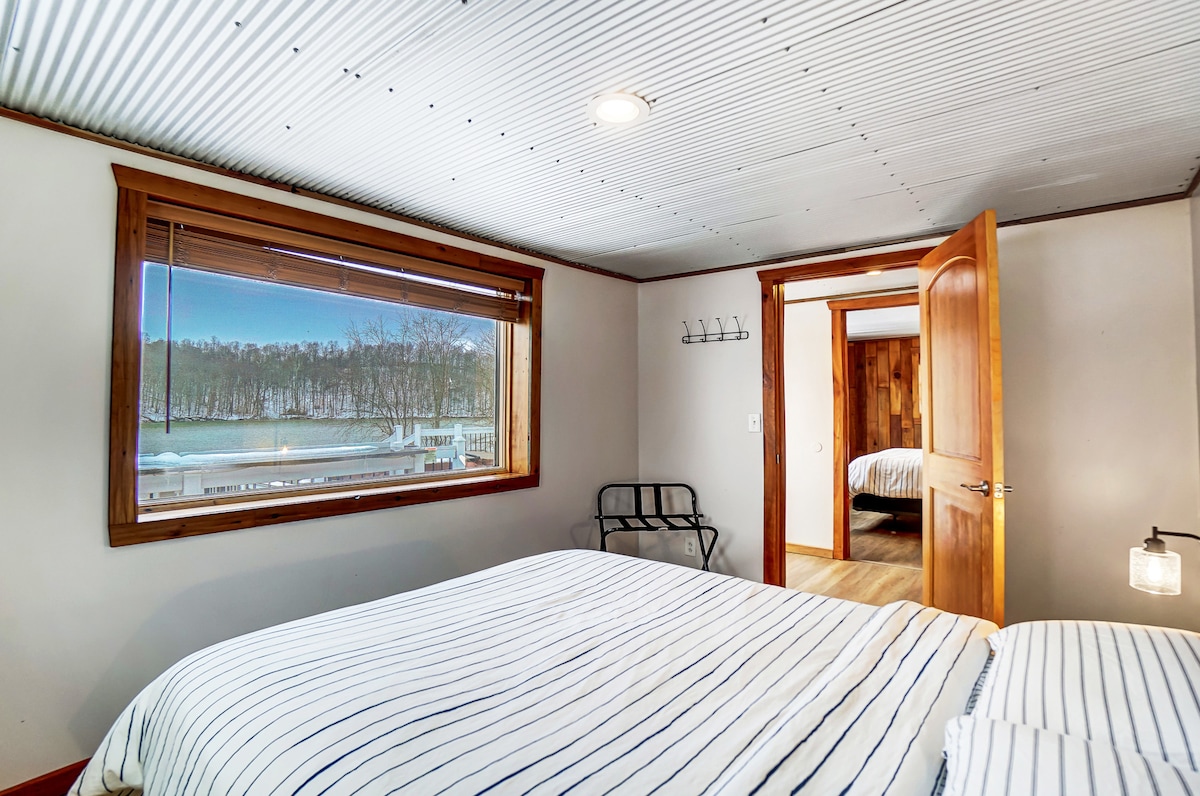 Bedroom 1 with a queen bed and unobstructed lake views.
