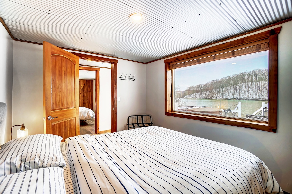 Bedroom 2 featuring a queen bed and unobstructed lake views.