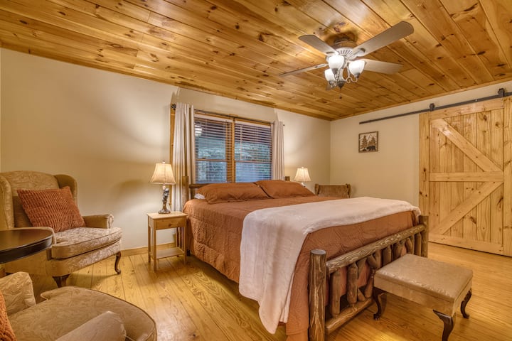 Welcome to the spacious master suite! Enjoy a king bed, barn door closet with a bassinet and playpen for your little one, a full bath, large walk-in closet, and a cozy sitting area to the left. The perfect retreat for relaxation and family comfort!