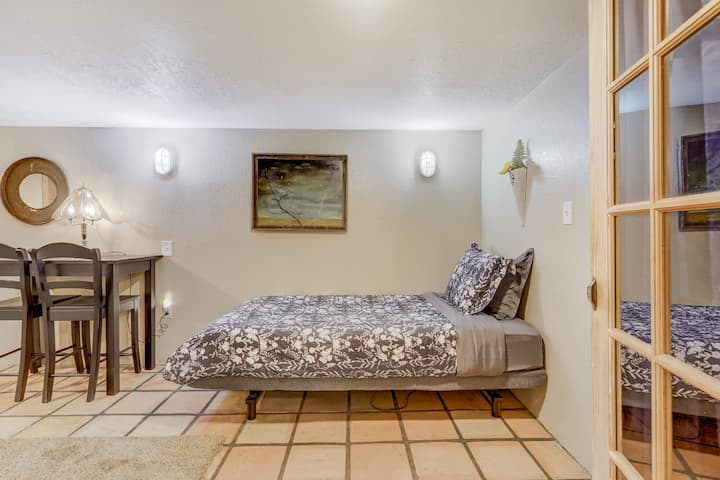 One of two twin beds and table/chairs